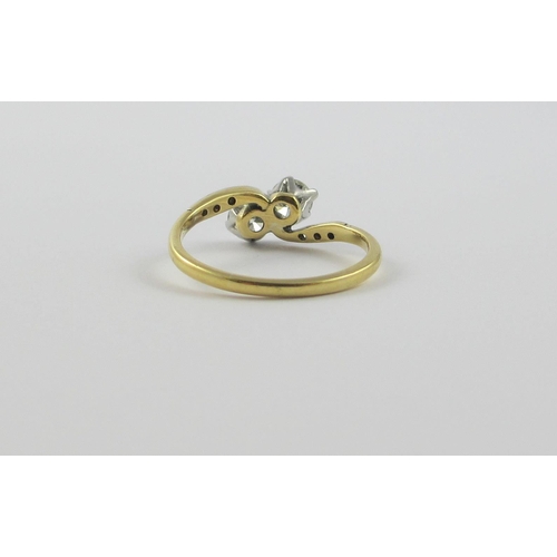 122 - A two stone diamond twist  ring of approx 0.60cts  set in 18ct yellow and white metal  with pave set... 