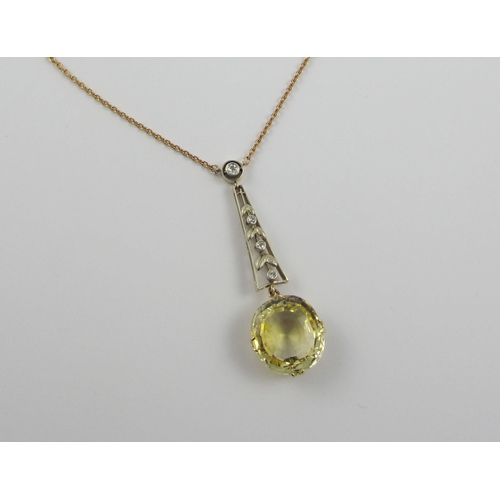 126 - A Edwardian citrine and diamond pendant  in 9ct yellow gold and white metal  the beautiful large cut... 