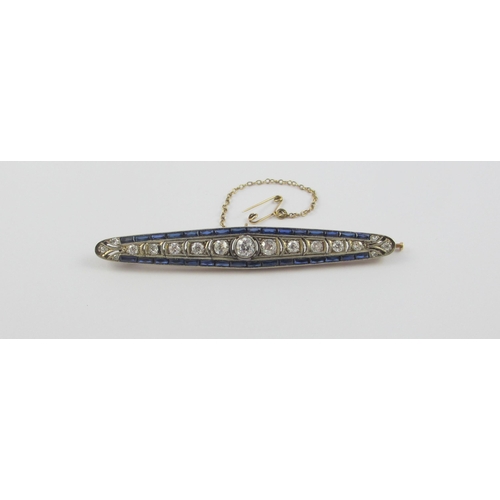 127 - An Edwardian diamond bar brooch set with old cut diamonds  and blue paste stones  in yellow and whit... 