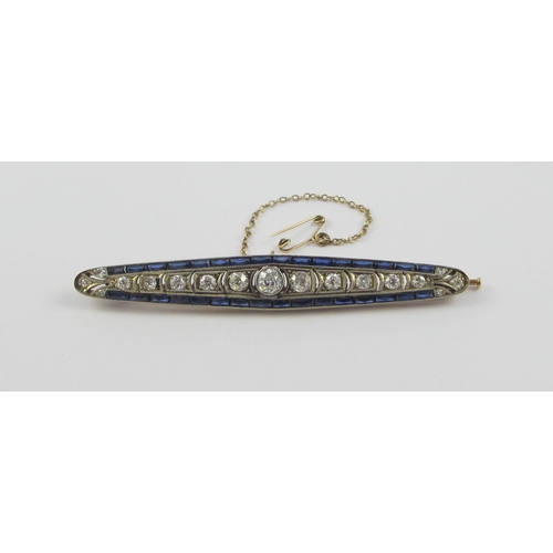 127 - An Edwardian diamond bar brooch set with old cut diamonds  and blue paste stones  in yellow and whit... 