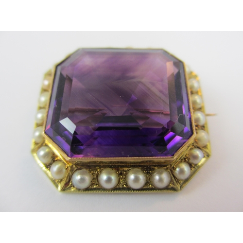 13 - A substantial 15ct Amethyst and pearl brooch. The central emerald cut amethyst with good colour and ... 