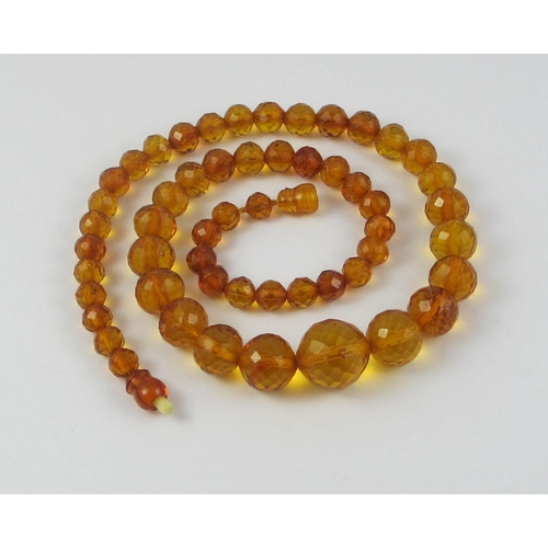 134 - A string of Faceted amber beads  ranging in size from largest approx 16mm to smallest approx 6.7mm  ... 