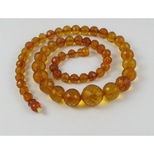 134 - A string of Faceted amber beads  ranging in size from largest approx 16mm to smallest approx 6.7mm  ... 