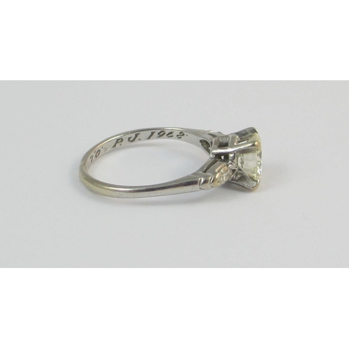 16 - A three stone diamond ring with marquise cut diamond shoulders. The central diamond of approx 0.99ct... 