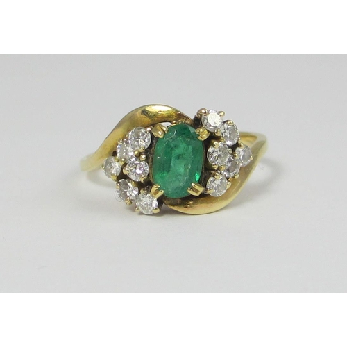 67 - An oval emerald claw set in a twist design with six diamonds off set to each shoulder. Approx ring s... 