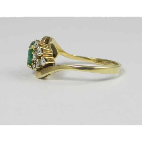 67 - An oval emerald claw set in a twist design with six diamonds off set to each shoulder. Approx ring s... 