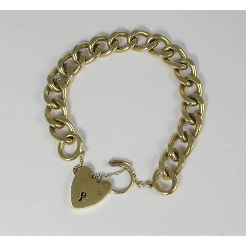 68 - A heavy 9ct yellow gold curb chain bracelet  hallmarked to every link  with heart shaped clasp. Appr... 