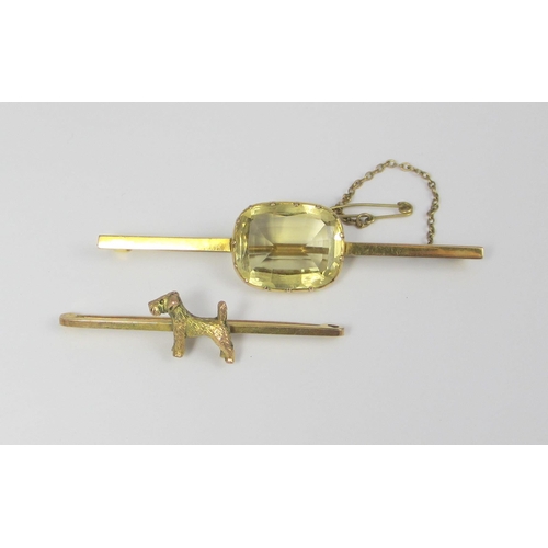 71 - A 9ct bar brooch mounted with a gold fox terrier dog  together with a 9ct bar brooch set with a larg... 