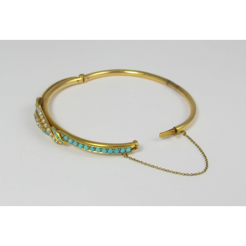 75 - A yellow metal bangle set with diamonds  seed pearls and turquoise. Weight approx 9.6gms