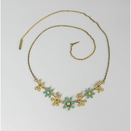 76 - A yellow metal Victorian style turquoise and seed pearl flower design necklet. Approx weight 11.7gms... 