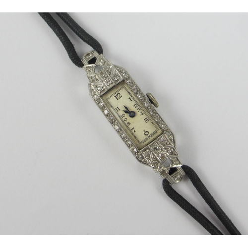 77 - An Art Deco ladies platinum and diamond cocktail watch. Approx weight 6.3gms.