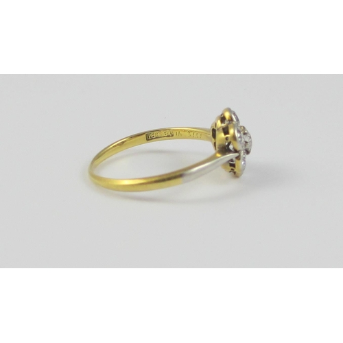 87 - A platinum and 18ct yellow gold diamond flower ring  approx diamond weight 0.70cts  the central diam... 