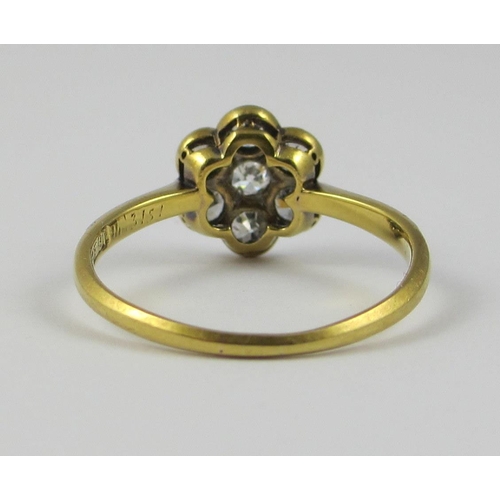 87 - A platinum and 18ct yellow gold diamond flower ring  approx diamond weight 0.70cts  the central diam... 