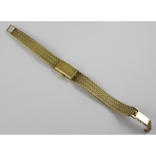 94 - a 9ct ladies wristwatch with integral 9ct woven strap. Approx weight 24.7gms.