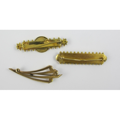 98 - A collection of three gold and yellow metal brooches  A 9ct classical revival example with a butterf... 