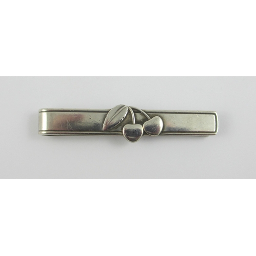 99 - A 'Georg Jensen' Cherry Heering tie clip. With the Georg Jensen stamp and sterling Denmark.