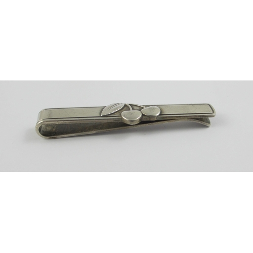 99 - A 'Georg Jensen' Cherry Heering tie clip. With the Georg Jensen stamp and sterling Denmark.