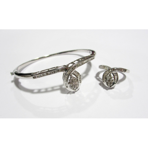 103 - An 18 ct white gold diamond set bangle and matching dress ring