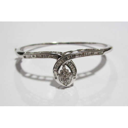 103 - An 18 ct white gold diamond set bangle and matching dress ring