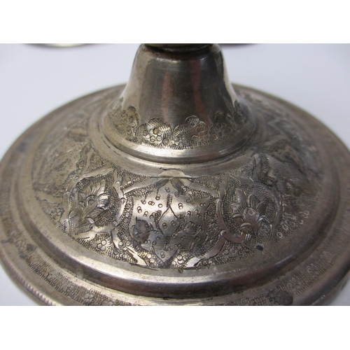 248 - An Eastern white metal candlestick