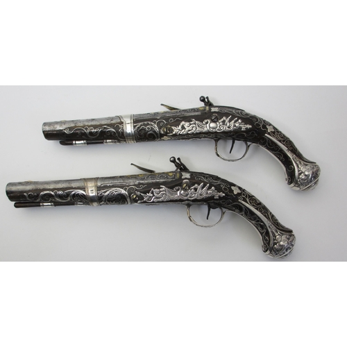 345 - A pair of silver overlaid flintlock pistols