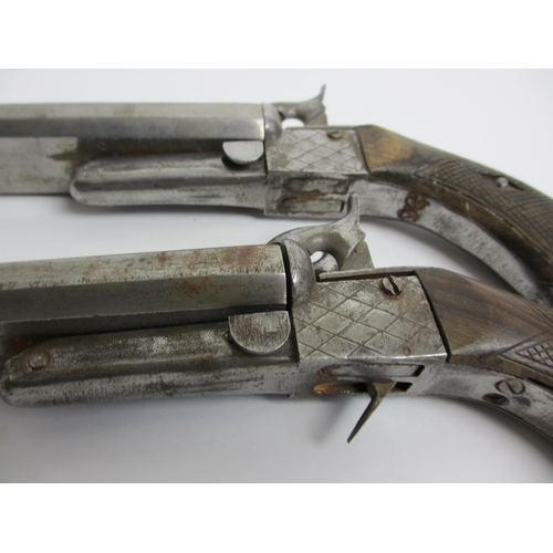 350 - A pair of steel double barrelled pistols