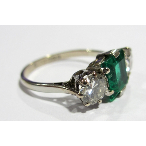 66 - An early 20 th century 18 ct white gold emerald and diamond three stone ring