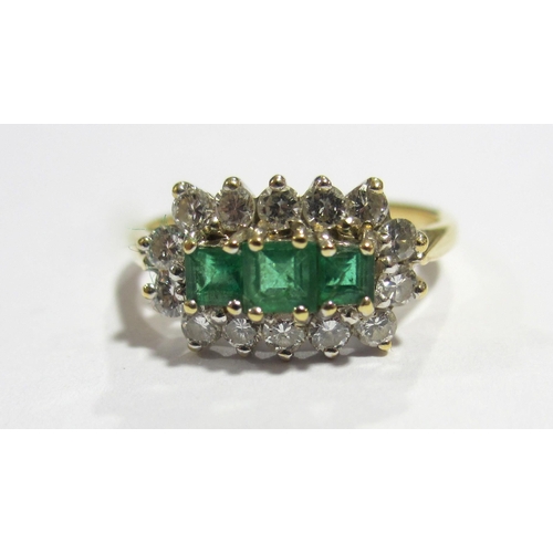 68 - An 18 ct gold emerald and diamond cluster ring