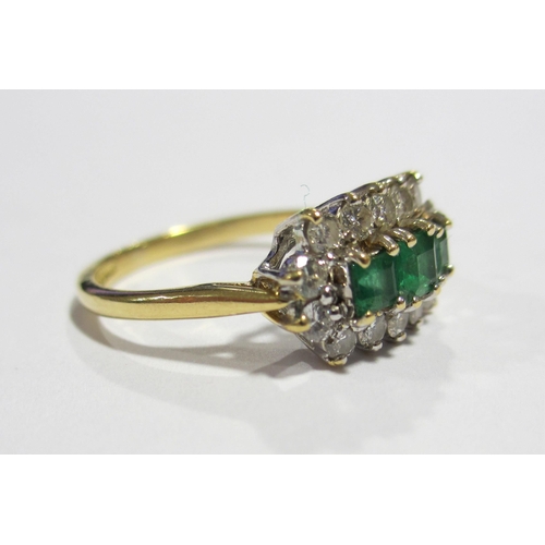 68 - An 18 ct gold emerald and diamond cluster ring