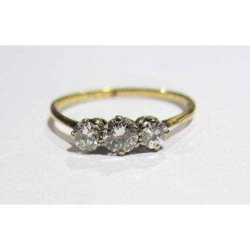 72 - An eighteen carat gold and platinum diamond three stone ring