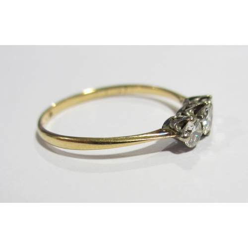 72 - An eighteen carat gold and platinum diamond three stone ring