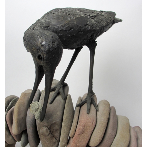 729 - A bronze model of a bird standing on a pebble built arched bridge