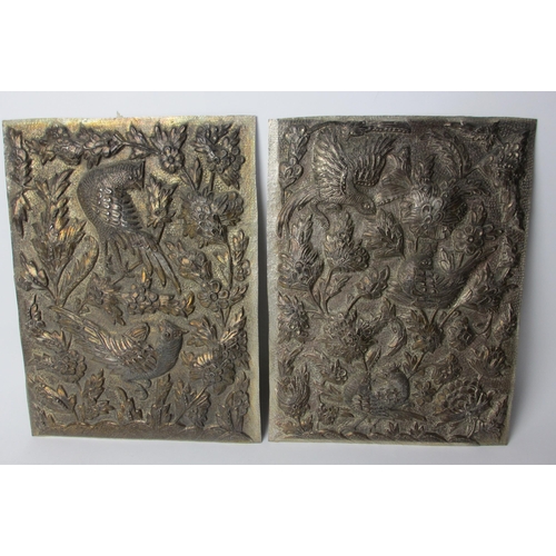 744 - A pair of embossed and hammered metal panels