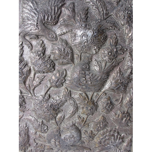 744 - A pair of embossed and hammered metal panels