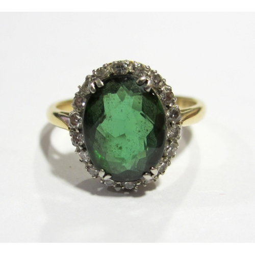 75 - An early 20 th century 18 ct gold and platinum green tourmaline and diamond cluster ring