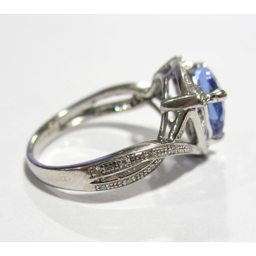 80 - A fourteen carat white gold tanzanite and diamond set dress ring