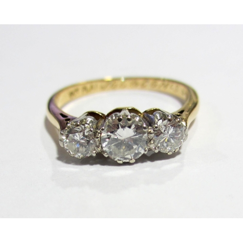 84 - An eighteen carat gold and platinum diamond three stone ring