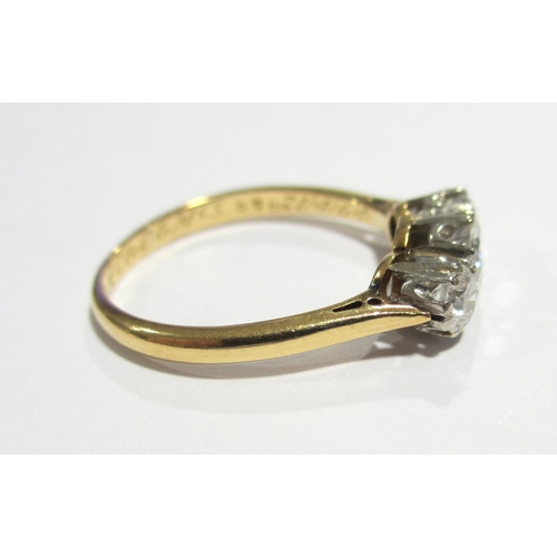 84 - An eighteen carat gold and platinum diamond three stone ring