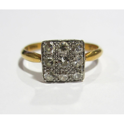 85 - A 1930's 18 ct gold and platinum diamond nine stone ring