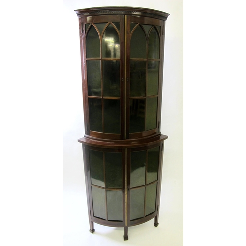 858 - An Edwardian mahogany bow fronted corner cabinet