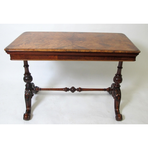 899 - A Victorian walnut fold over games table