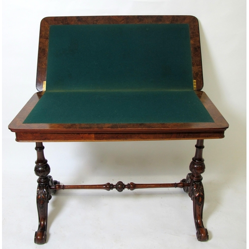 899 - A Victorian walnut fold over games table