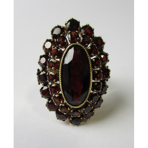 62 - A fourteen carat gold garnet cluster ring