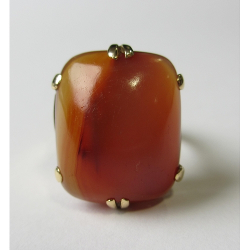 69 - An eighteen carat gold cornelian single stone ring