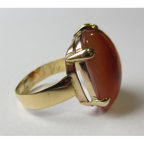 69 - An eighteen carat gold cornelian single stone ring