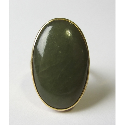 73 - A fourteen carat gold jade single stone ring