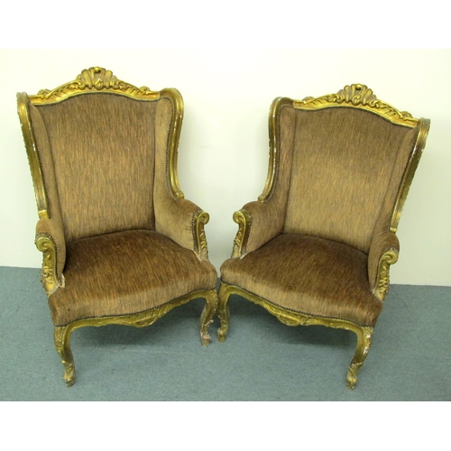 827 - A pair of giltwood wing armchairs