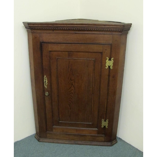 838 - A Georgian oak corner cupboard