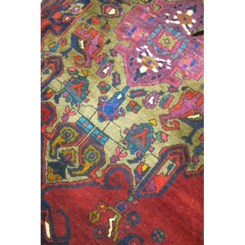 875 - An Iranian multicoloured floor rug with geometric design 285cm long x 172cm wide