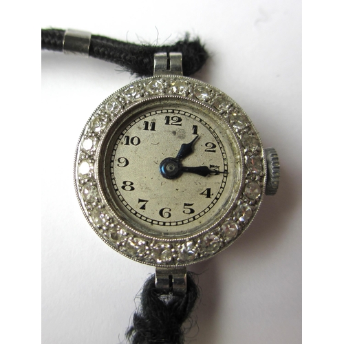 99 - A ladies early 20 th century platinum watch with diamond bezel